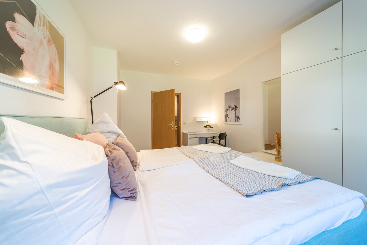 Schlafzimmer mit Doppelbett und großem Schrank